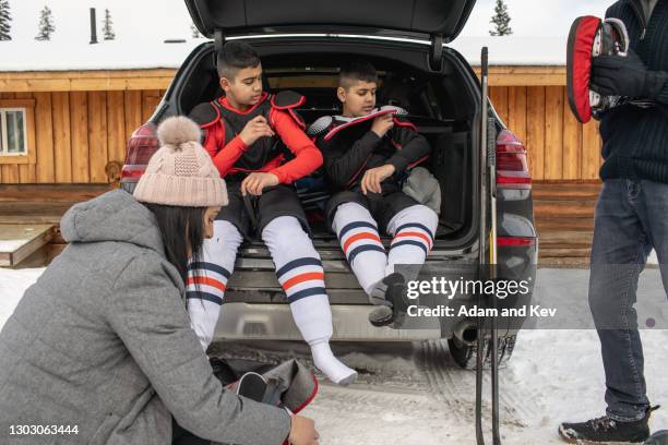 brothers dress in ice-hockey equipment - hockey mom stock pictures, royalty-free photos & images