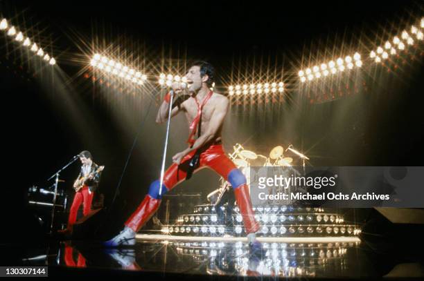From left to right, musicians John Deacon and Freddie Mercury of the British rock band Queen perform in concert at the Forum on July 9, 1980 in...