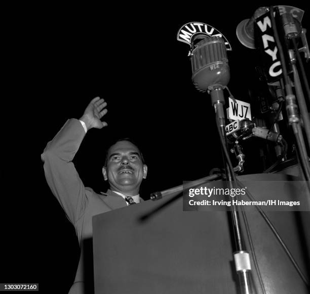 American lawyer, prosecutor, and politician Thomas E. Dewey waves and smiles at the dais while he campaigns for the Presidency circa 1948 in New...