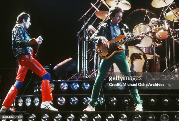 From left to right, singer Freddie Mercury and musician John Deacon of British rock band Queen in concert, 1980.