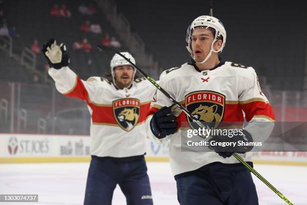 Juho Lammikko of the Florida Panthers celebrates his first period goal in front of teammate MacKenzie Weegar while playing the Detroit Red Wings at...
