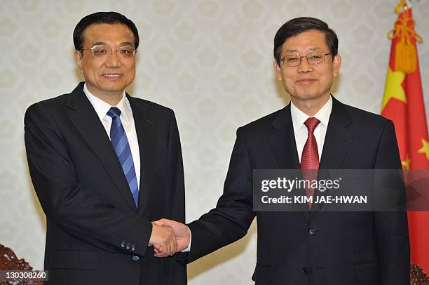 South Korean Prime Minister Kim Hwang-Sik shakes hands with Chinese Vice Premier Li Keqiang during their meeting in Seoul on October 26, 2011. Li is...