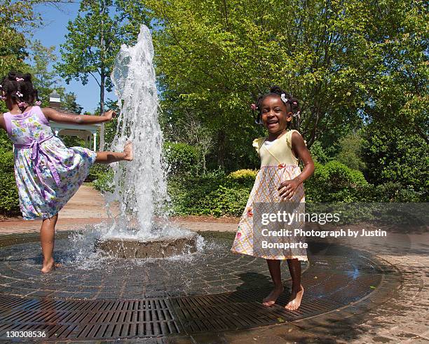 girls playing in fountain - charlotte north carolina spring stock pictures, royalty-free photos & images