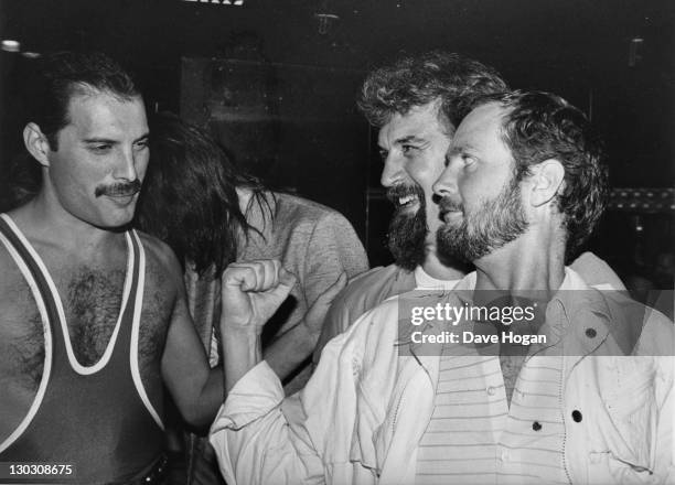 From left to right, singer Freddie Mercury of British rock band Queen with comedian Billy Connolly and DJ Kenny Everett, during Mercury's 38th...
