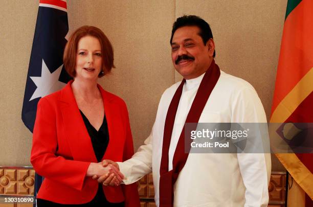 Australian Prime Minister Julia Gillard shakes hands with Sri Lanka President Mahinda Rajapaksa during a bilateral summit ahead of the Commonwealth...