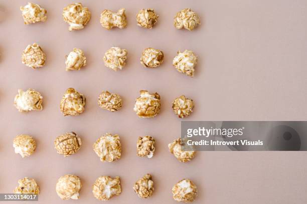 caramel sweet popcorn pattern on beige background with copy space - caramel corn stock pictures, royalty-free photos & images