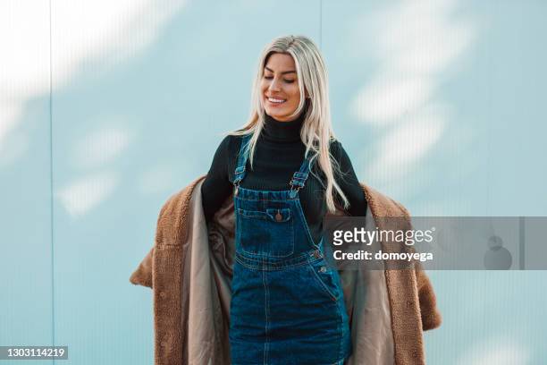 cheerful woman on a sunny winter day in the city - fake fur stock pictures, royalty-free photos & images