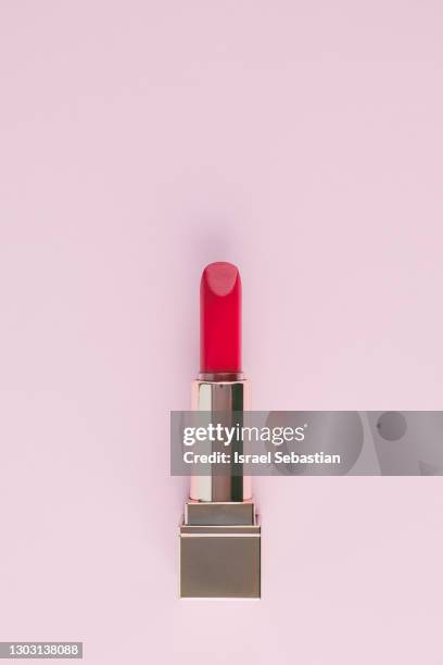 close-up of an open pink lipstick isolated on light pink background. make-up concept - human lips stock photos et images de collection