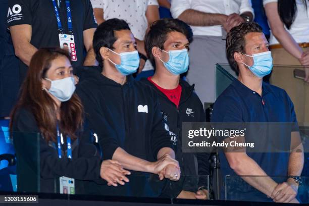 Entourage of Naomi Osaka of Japan including her coach Wim Fissette and physical trainer Natsuko Mogi look on during the presentation ceremony...