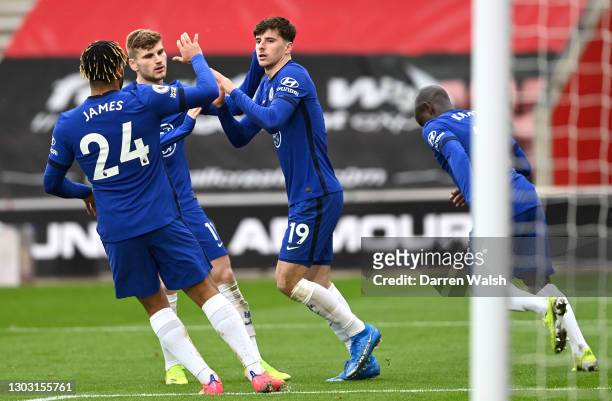 Mason Mount of Chelsea celebrates with teammates Reece James and Timo Werner after scoring his team's first goal during the Premier League match...