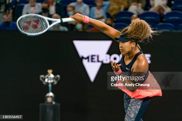 Naomi Osaka of Japan serves a forehand with the Daphne Akhurst Memorial Cup in the background in her Women’s Singles Final match against Jennifer...