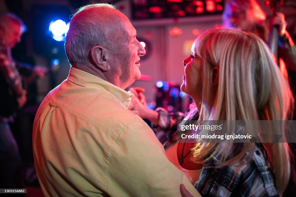 Lovely senior couple showing their dance moves on dance floor during date night
