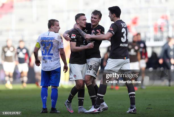 Sebastian Ohlsson, Eric Smith and Igor Matanovic of FC St. Pauli celebrate following their team's victory in the Second Bundesliga match between FC...