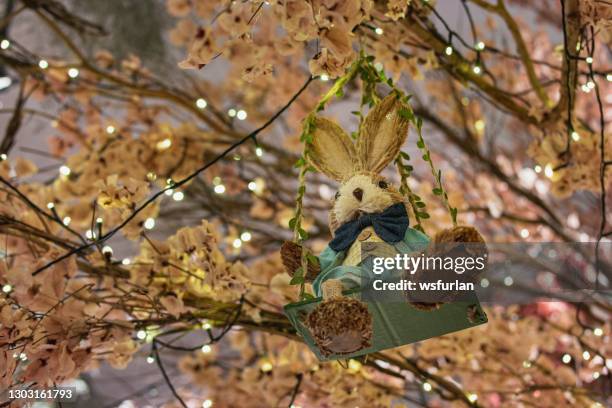 easter bunny hanging on the tree - easter bunny stock pictures, royalty-free photos & images