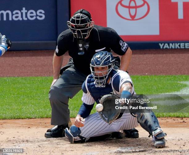 August 30: Catcher Gary Sanchez of the New York Yankees catches a pitch as umpire Chris Conroy looks on in game 1 of an interleague MLB baseball...