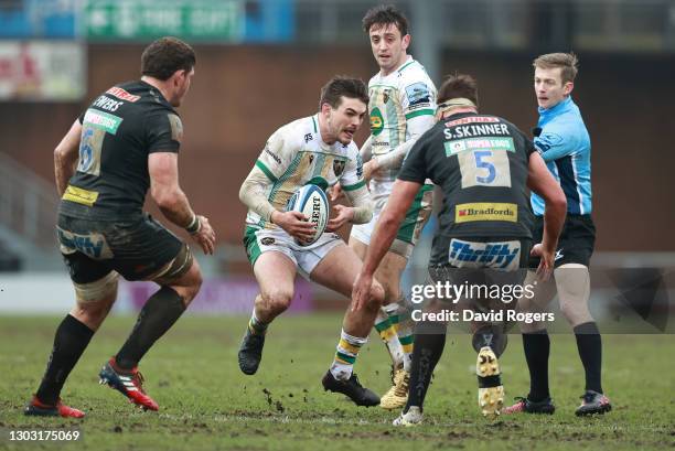 Exeter Chiefs forwards Dave Ewers and Sam Skinner converge to confront Northampton Saints fly half George Furbank during the Gallagher Premiership...