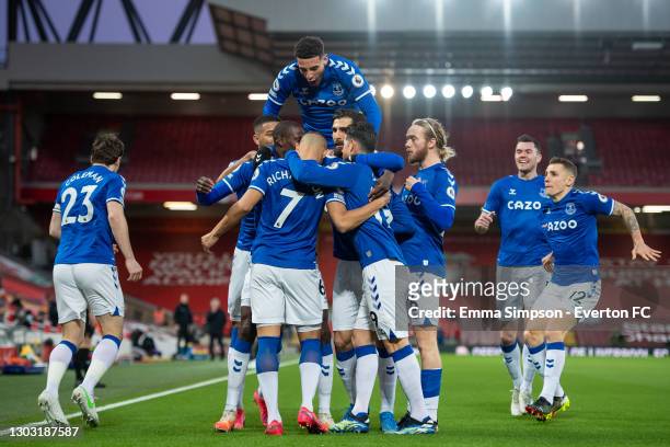 Richarlison of Everton celebrates scoring his teams first goal with team mates during the Premier League match between Liverpool and Everton at...