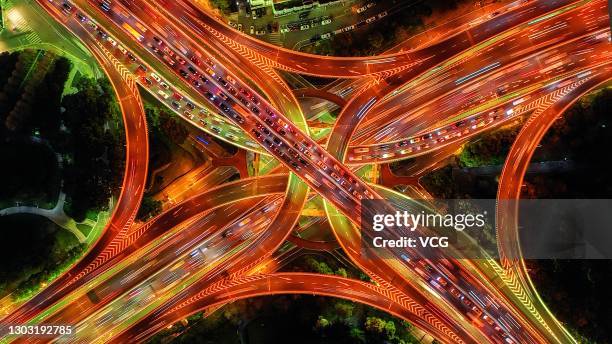 Aerial view of an illuminated highway overpass at night on February 19, 2021 in Shanghai, China.