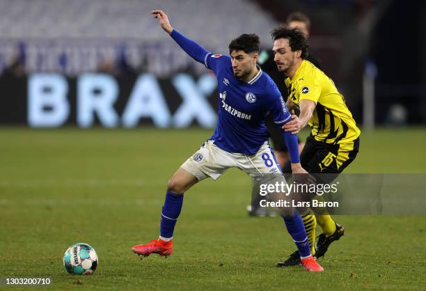 Suat Serdar of FC Schalke 04 is challenged by Mats Hummels of Borussia Dortmund during the Bundesliga match between FC Schalke 04 and Borussia...