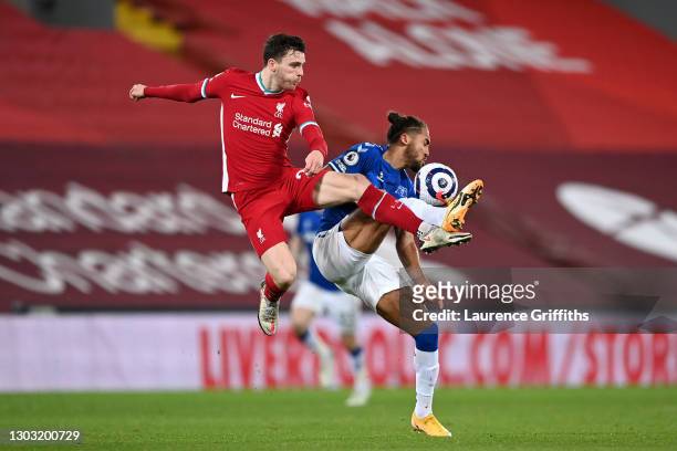 Andrew Robertson of Liverpool battles for possession with Dominic Calvert-Lewin of Everton during the Premier League match between Liverpool and...