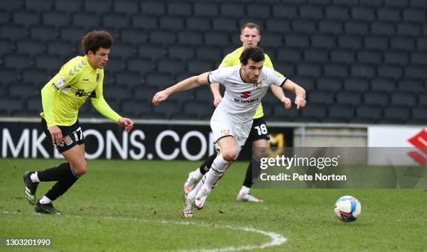 Scott Fraser of Milton Keynes Dons moves forward with the ball away from Shaun McWilliams of Northampton Town during the Sky Bet League One match...