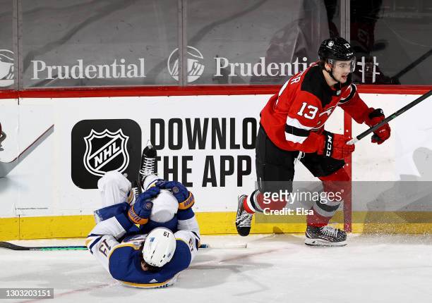 Jake McCabe of the Buffalo Sabres is injured on this play as he collides with Nico Hischier of the New Jersey Devils in the third period at...