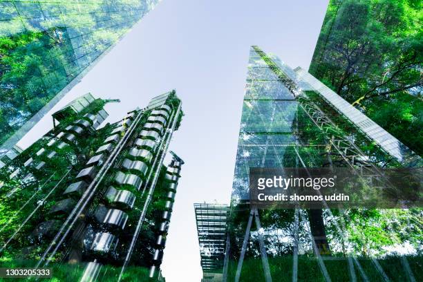 double exposure of trees and buildings - finance and economy photos stock pictures, royalty-free photos & images