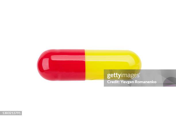 yellow and red gelatine pill isolated on white background - red pill stock pictures, royalty-free photos & images