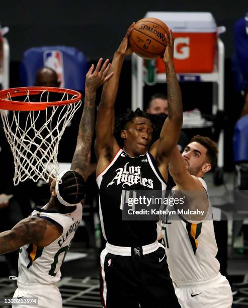 Terance Mann of the Los Angeles Clippers grabs the rebound against Jordan Clarkson and Georges Niang of the Utah Jazz during the fourth quarter at...