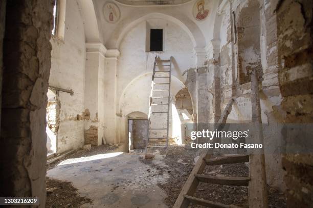 Interior views of the church of Craco, San Nicola di Bari, abandoned and defaced by vandals who have stolen marble slates, crosses, and tombs on...