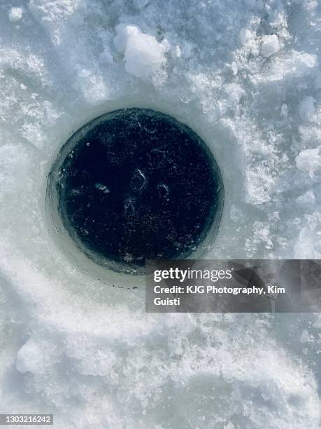 ice fishing hole - ice fishing stock pictures, royalty-free photos & images