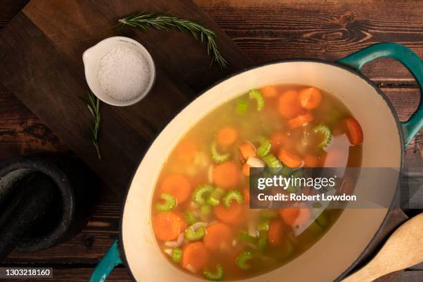 the ingredients for a soup base simmer in a pot - celery soup stock pictures, royalty-free photos & images