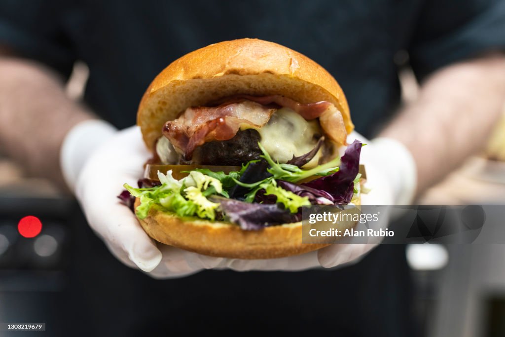 Professional chef cooking the perfect burger in a new kitchen.