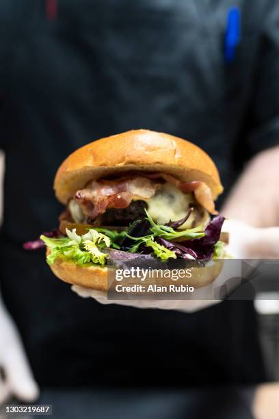 professional chef cooking the perfect burger in a new kitchen. - chef rubio stock pictures, royalty-free photos & images