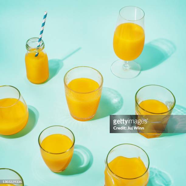 glasses of orange juice - orange juice stock-fotos und bilder