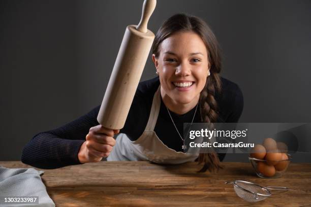 smiling young female chef studio portrait - rolling pin stock pictures, royalty-free photos & images