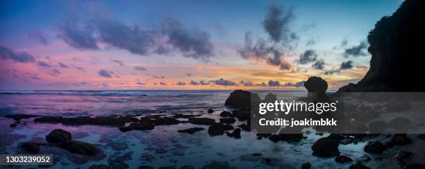 colorful sunset along the coast in bali indonesia - melasti ceremony in indonesia stock pictures, royalty-free photos & images