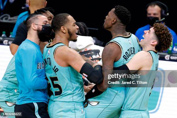 Terry Rozier of the Charlotte Hornets celebrates with his team after hitting the game-winning three point basket during the final seconds of the...