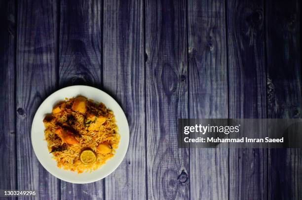 karachi chicken biryani with potatoes made in sella rice in white plate - prepared potato stock pictures, royalty-free photos & images