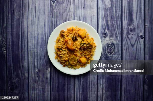 karachi chicken biryani with potatoes made in sella rice in white plate - prepared potato stock pictures, royalty-free photos & images