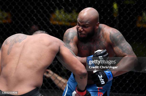 Derrick Lewis punches Curtis Blaydes in a heavyweight bout during the UFC Fight Night event at UFC APEX on February 20, 2021 in Las Vegas, Nevada.