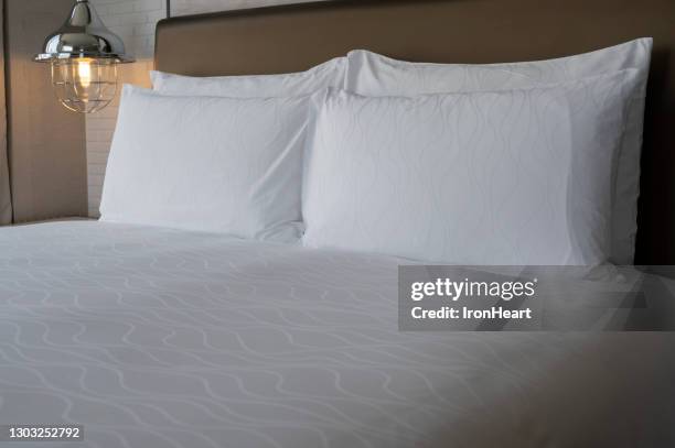 white bed and pillow - comfortable foto e immagini stock