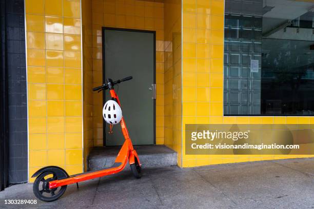 electric scooter parked - mobility scooters stock pictures, royalty-free photos & images