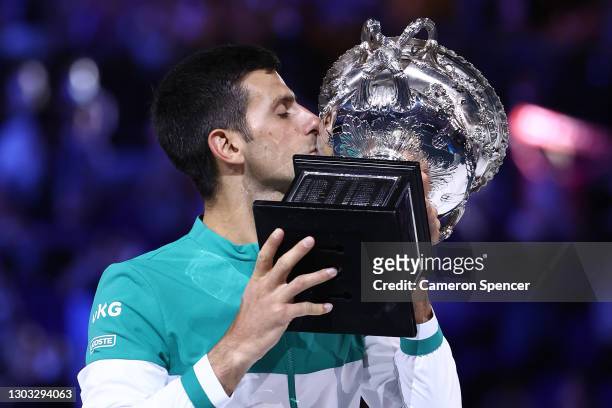 Novak Djokovic of Serbia holds the Norman Brookes Challenge Cup as he celebrates victory in his Men’s Singles Final match against Daniil Medvedev of...