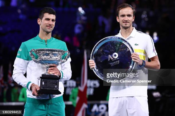 Daniil Medvedev of Russia holds the runners up plate as Novak Djokovic of Serbia holds the Norman Brookes Challenge Cup as he celebrates victory in...