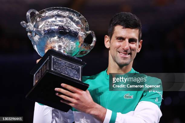 Novak Djokovic of Serbia holds the Norman Brookes Challenge Cup as he celebrates victory in his Men’s Singles Final match against Daniil Medvedev of...