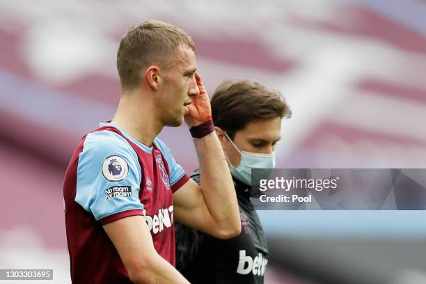 Tomas Soucek of West Ham United holds his head after an injury during the Premier League match between West Ham United and Tottenham Hotspur at...