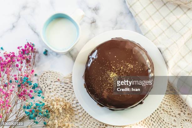 whole chocolate sachertorte cake on table with decoration - sachertorte stock pictures, royalty-free photos & images
