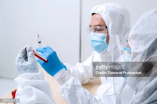 close up picture of scientist wearing personal protective equipment or ppe  to do experiment about covid-19 or coronavirus vaccine in the lab. - batting isolated stock pictures, royalty-free photos & images