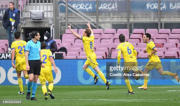 Alex Fernandez of Cadiz CF celebrates with team mates Jose Mari and Isaac Carcelen after scoring their side's first goal from the penalty spot during...